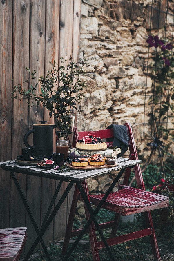 Fig Tarts With Chantilly Cream And Salted Caramel On Wooden Table In Garden Photograph by Claudia Gdke