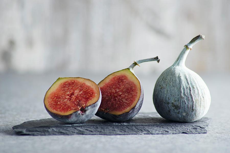 Figs, Whole And Halved, On A Piece Of Slate Photograph by Brigitte ...