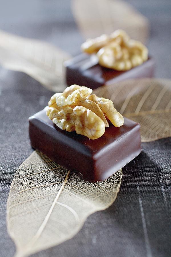 Filled Chocolates Topped With Walnuts Photograph by Pizzi, Alessandra