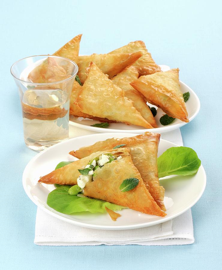 Filo Pastry Triangles Filled With Feta Cheese And Broad Beans Photograph by Franco Pizzochero