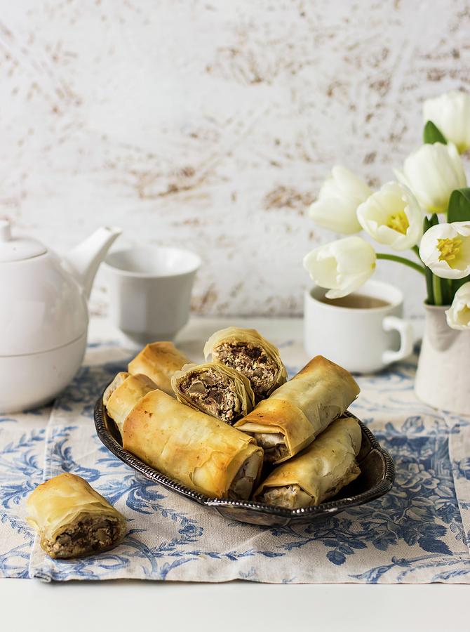 Filo Rolls With Manouri Cheese, Walnuts, Raisins, And Mint; Tea, White Tulips Photograph by Zuzanna Ploch