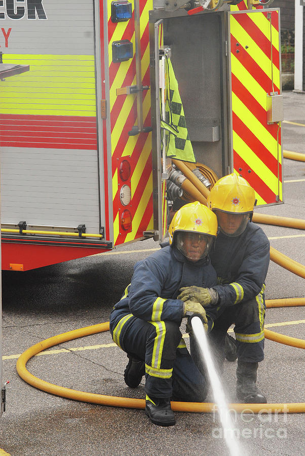 Firefighters Dousing Out A Flame by Science Photo Library