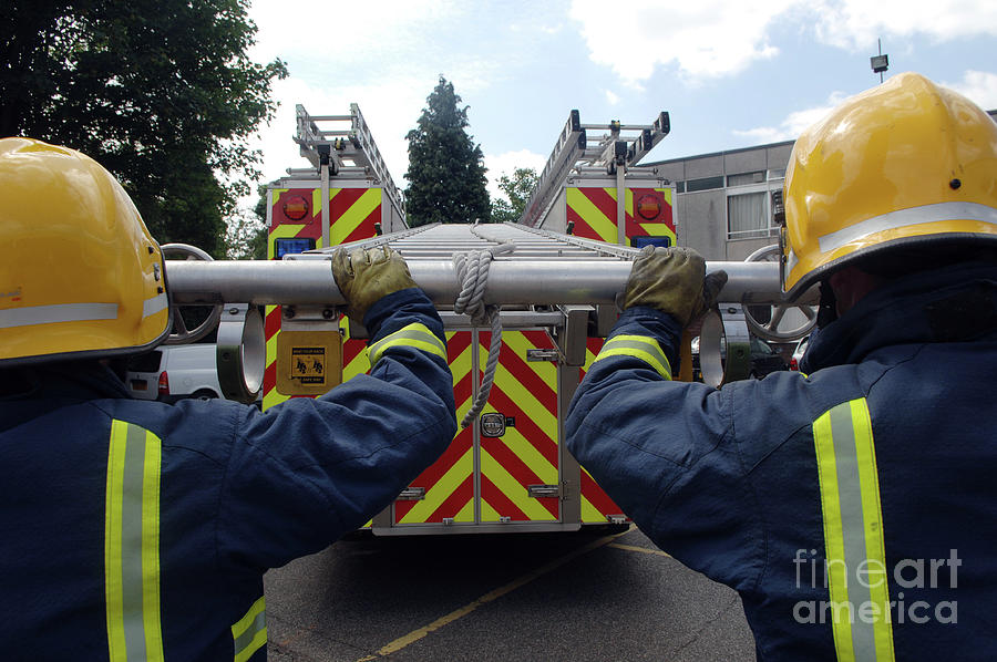 Firefighters Extending Ladder Photograph by Medicimage / Science Photo Library