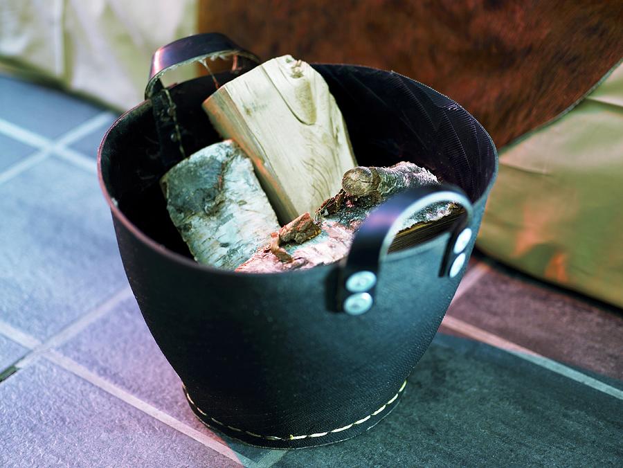 Firewood In A Black Leather Basket Photograph by Per Magnus Persson