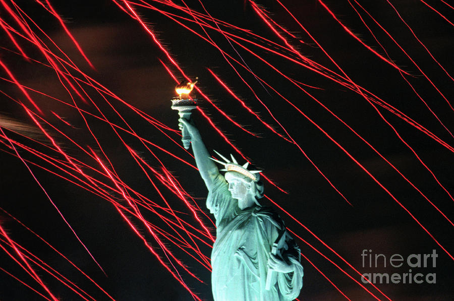 Fireworks Surrounding Statue Of Liberty Photograph by Bettmann