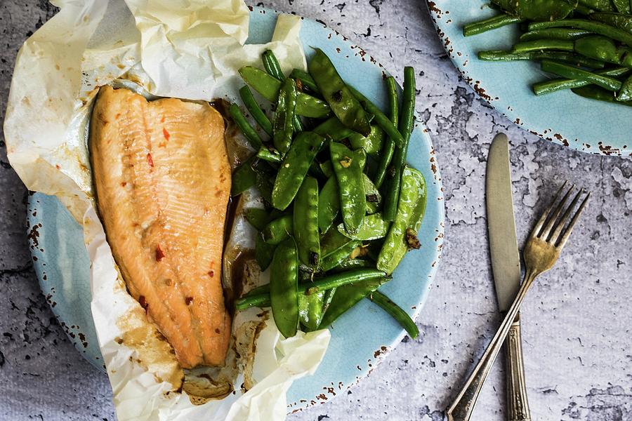 Fish Baked In Paper With Beans And Mange Tout Photograph by Alena Haurylik