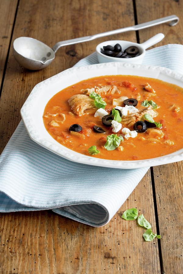Fish Fillet In Tomato Sauce With Feta Cheese And Olives Photograph by Claudia Timmann