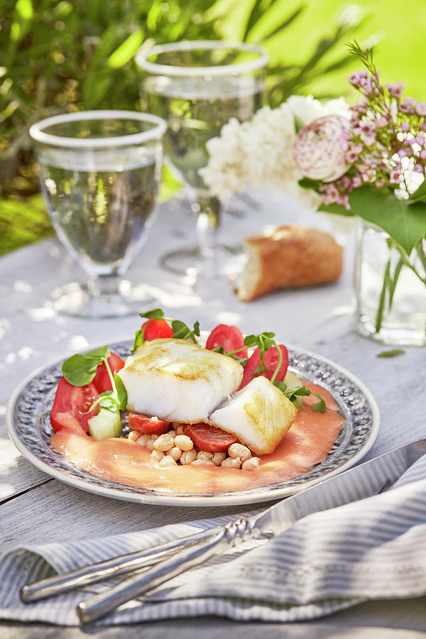 Fish Fillets With Tomato Cream Sauce On A Summery Table Outdoors Photograph by Winfried Heinze