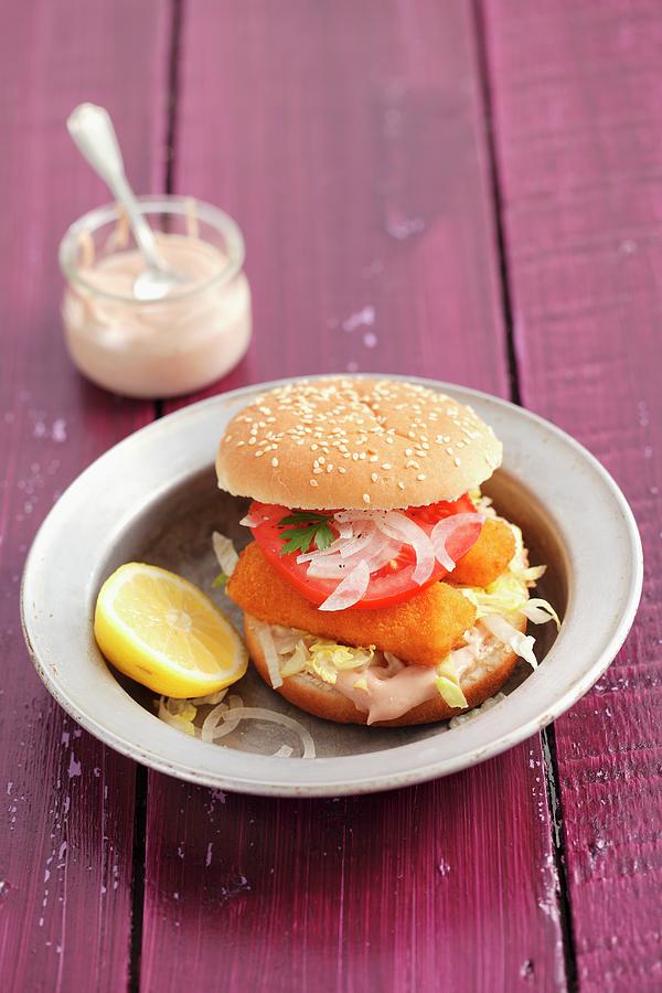 Fish Fingers In A Burger Bun With Onions And Tomato Photograph by Rua Castilho