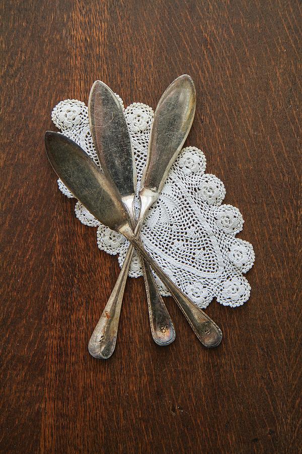 Fish Knives On A Doily Photograph by Anne Faber