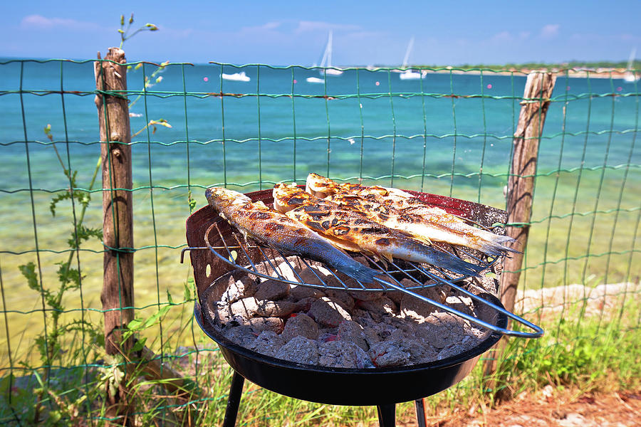 Fish on the grill by the mediterranean beach, idyllic vacation f Photograph by Brch Photography