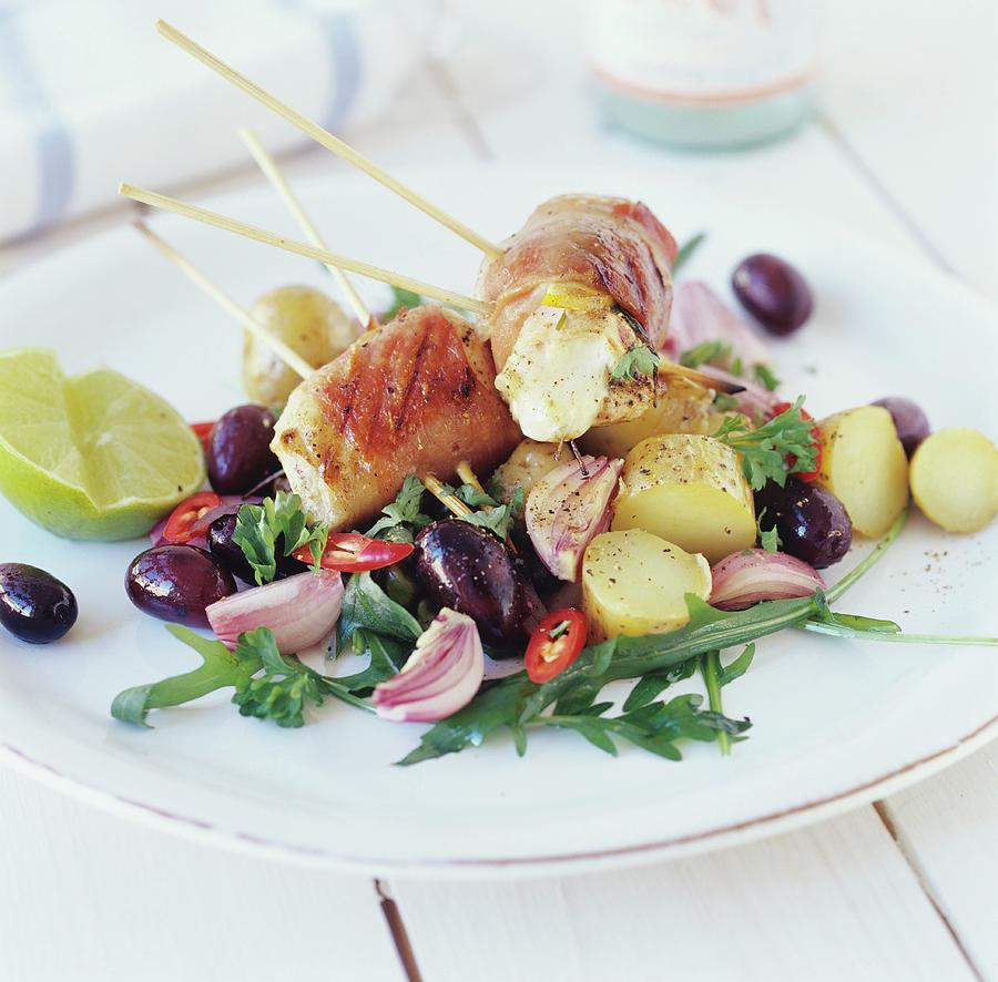 Fish Skewers With Bacon On Potato & Olive Salad Photograph by Tine Guth Linse
