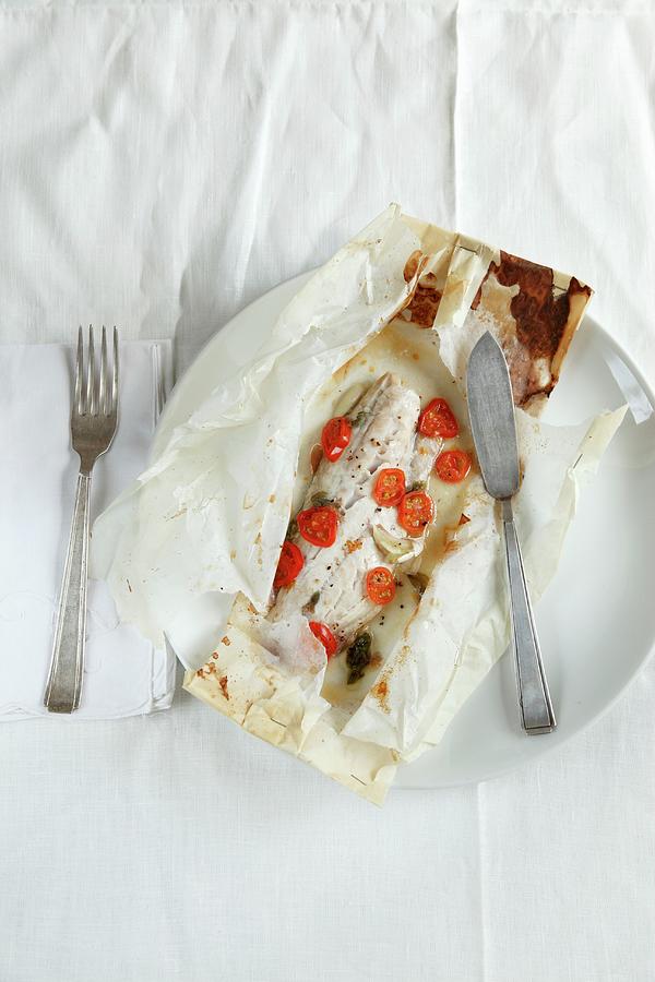 Fish With Cherry Tomatoes Baking Parchment Paper Photograph by Danya Weiner
