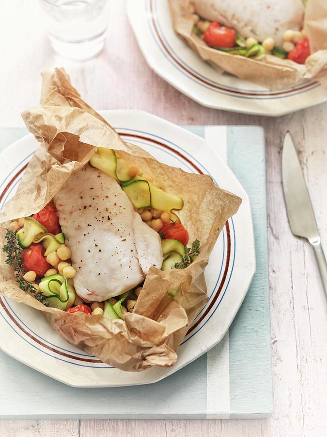 Fish With Courgettes, Chickpeas And Tomatoes In Parchment Paper Photograph by Jonathan Gregson