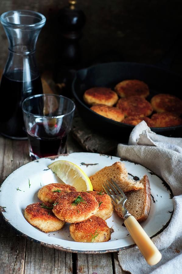 Fishcakes In Breadcrumbs With A Slice Of Bread And Lemon Photograph by Irina Meliukh