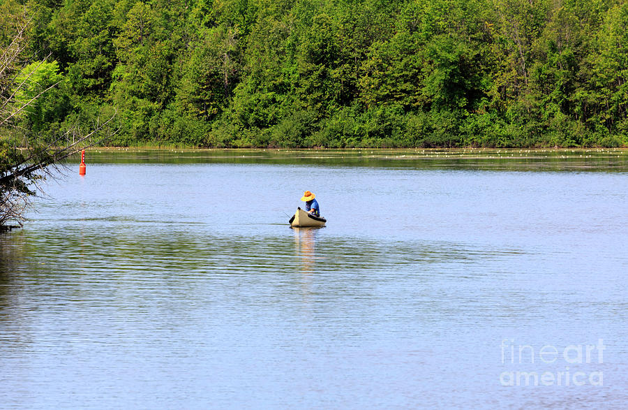 Fisherman in a traditional canoe on the Trent Severn Waterway Photograph by Louise Heusinkveld