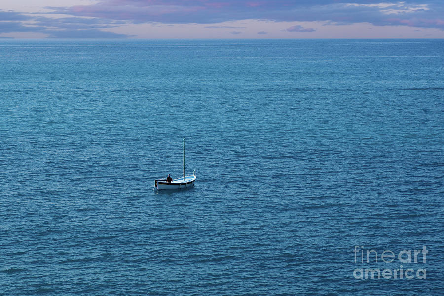 Fisherman in Small Boat in Ocean by SAJE Photography