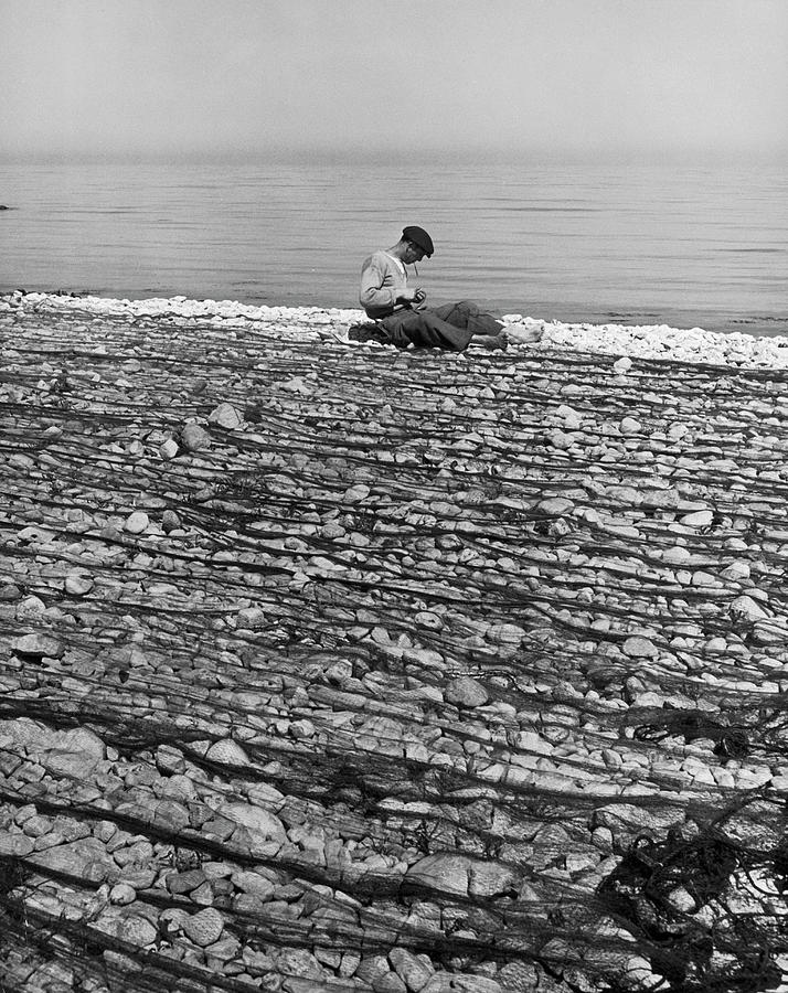 Fisherman Inspecting And Mending Nets Photograph by Alfred Eisenstaedt Fisherman Inspecting And Mending Nets Photograph by Alfred Eisenstaedt