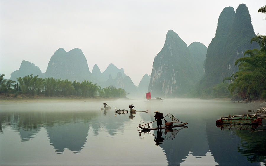 Fishermen On Li River Photograph by Kingwu