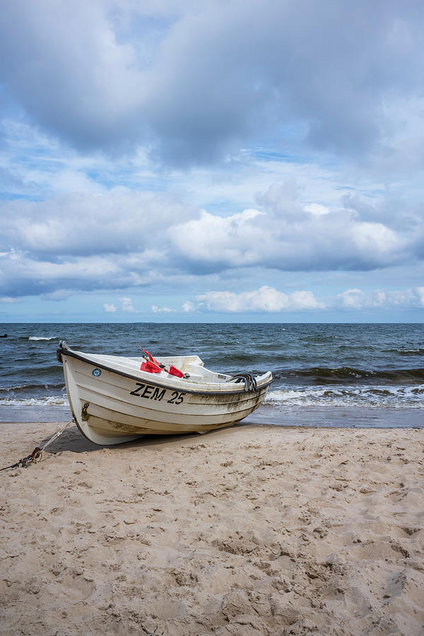 Fishing Boat On The Baltic Sea Beach With Cloudy, Dramatic Sky And Rough Sea, Usedom, Mecklenburg-western Pomerania, Germany Photograph by Max Bauerfeind
