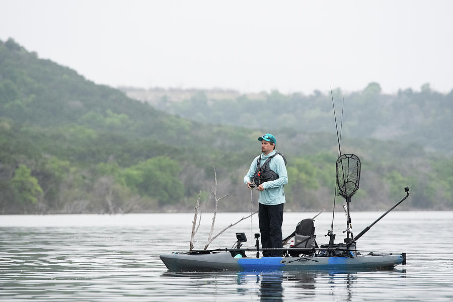 Fishing For Bass While Standing On Kayak On A Texas Lake Photograph by