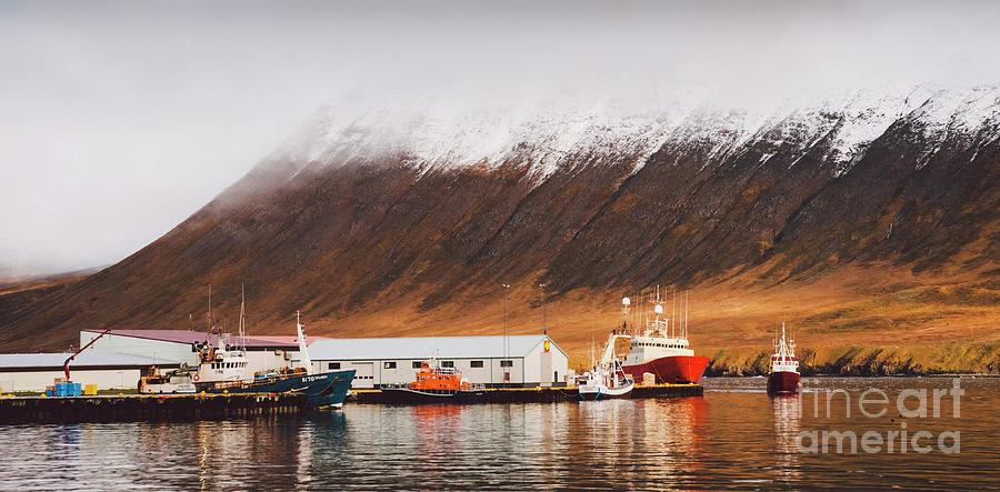 Fishing port of the village of Seydisfjordur, in Iceland, with vibrant colors and reflections in the sea of fishing boats. Photograph by Joaquin Corbalan