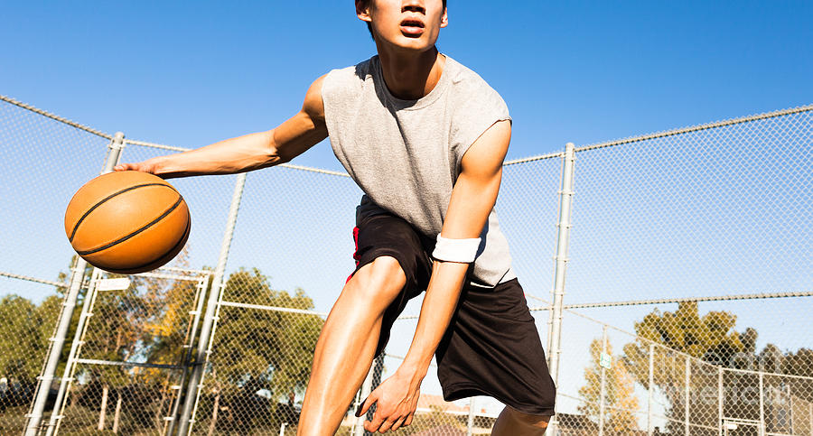 College Photograph - Fit Male Playing Basketball Outdoor by Pkpix