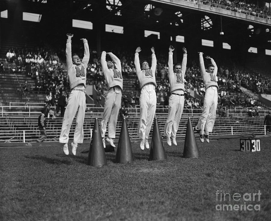 Five Male Maryland Cheerleaders Jumping Photograph by Bettmann