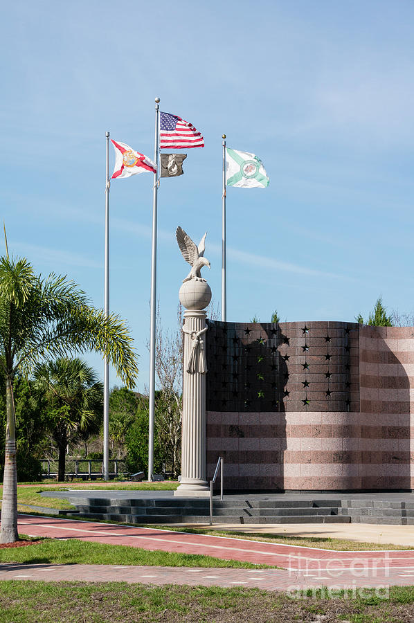 Flags fly at the Collier County Freedom Memorial at Freedom Park Photograph by William Kuta