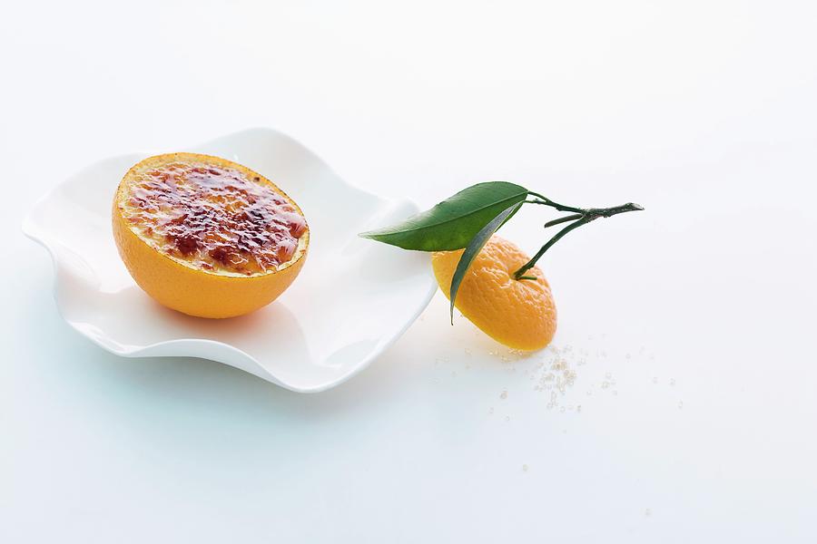 Flambed Spiced Yoghurt Served In An Orange Half Photograph by Michael Wissing