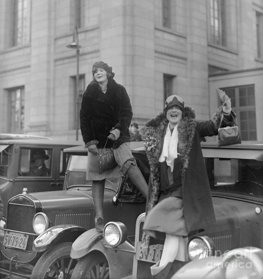 Flappers Standing On Car Hoods Photograph by Bettmann