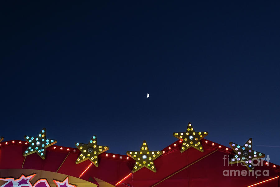 Flat background of blue sky with small moon and luminous light bulbs. Photograph by Joaquin Corbalan