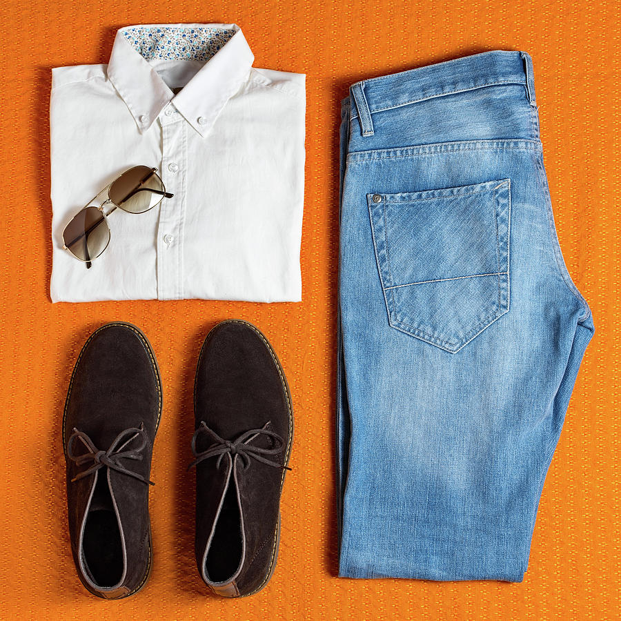 Download Flat lay men's clothing on orange background Photograph by ...