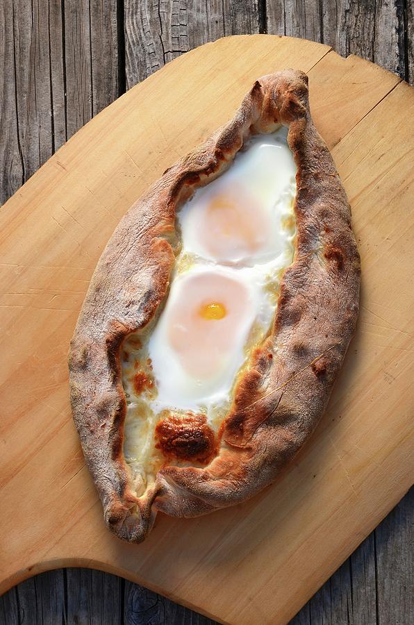 Flatbread Filled With Cheese And Eggs Photograph by Robert Dodds