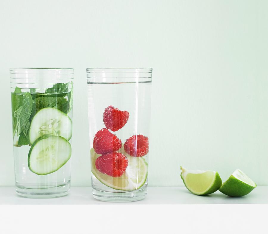 Flavoured Water cucumber-mint, And Raspberry-lime With Lime Wedges Photograph by Allison Dinner