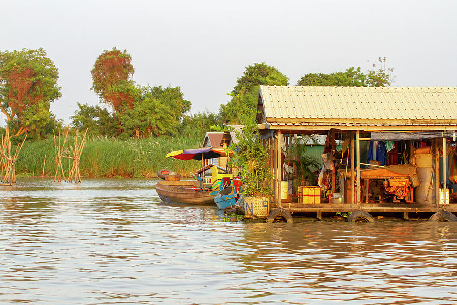 Floating houses and boats on Tonle Sap River in Cambodia Photograph by Karen Foley