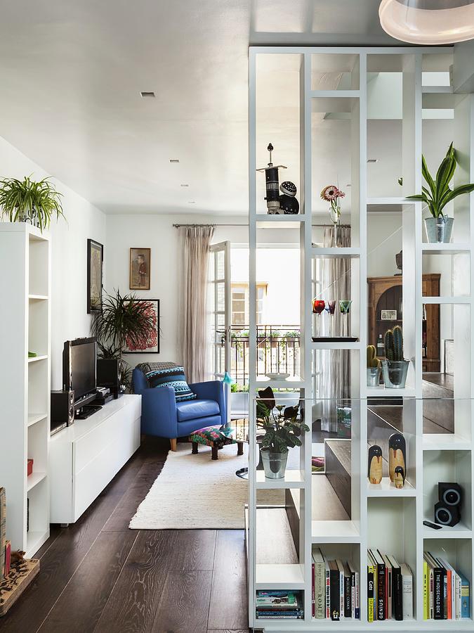 Floor-to-ceiling Bookcase As Partition With View Of Blue Leather ...