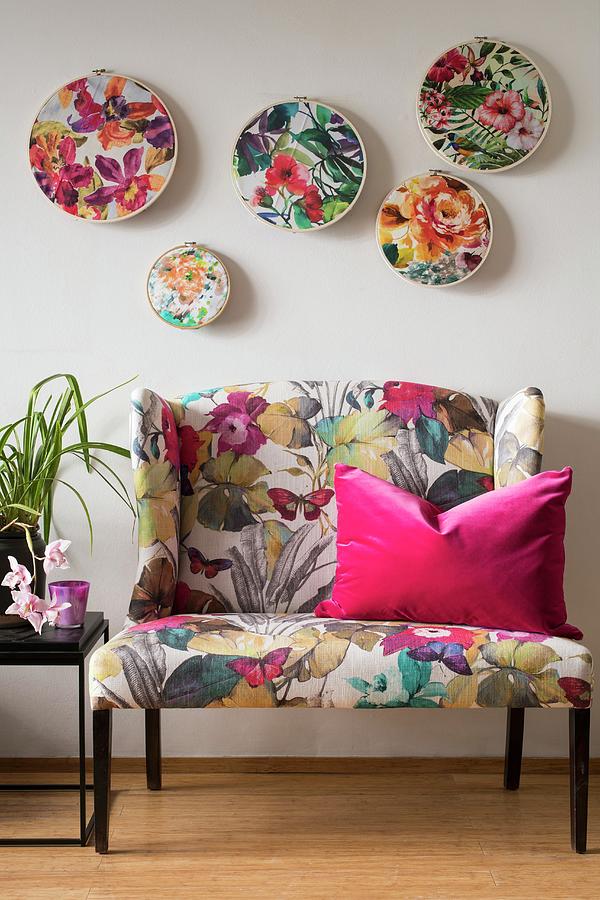 Floral Fabrics In Embroidery Hoops Mounted On Wall Above Sofa With Floral Print Upholstery Photograph by Great Stock!