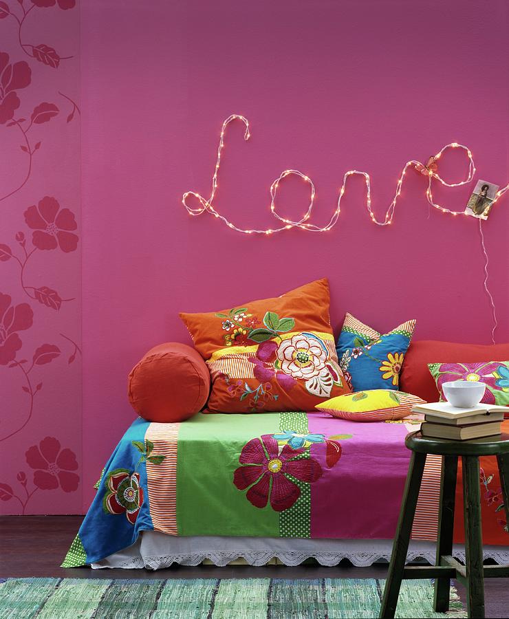 Floral Throws And Cushions On Sofa Below Motto love Written In