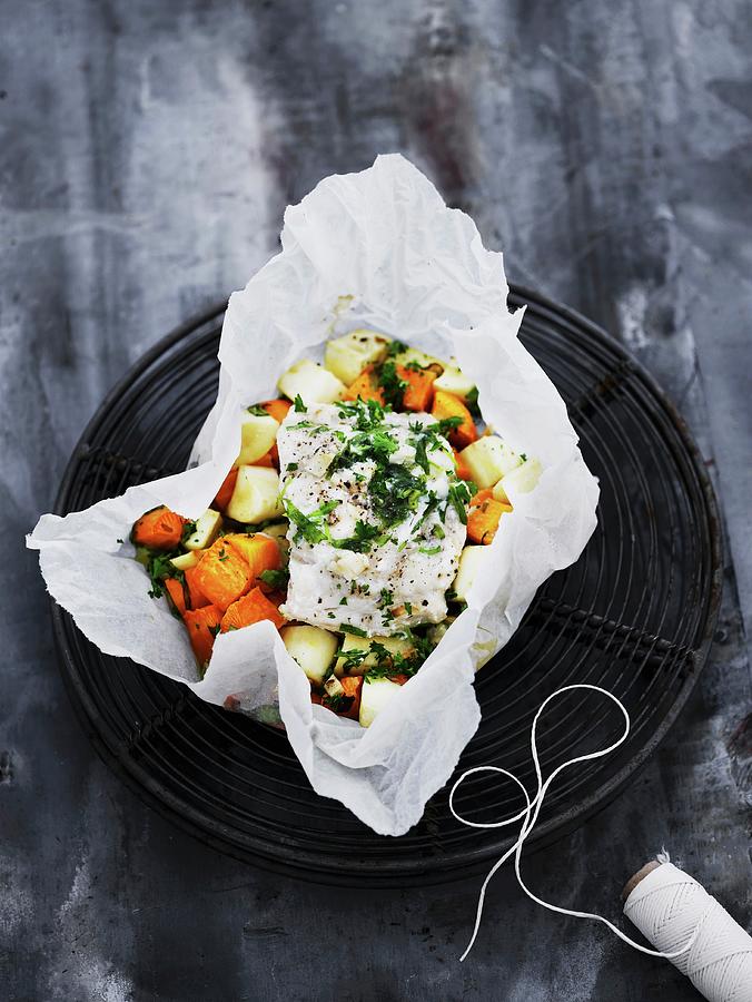 Flounder On Root Vegetables In Parchment Paper Photograph by Mikkel ...