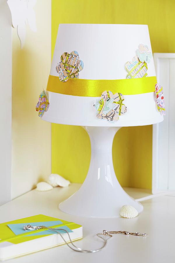 Flower-shapes Cut From Map And Golden Ribbon Decorating Lampshade Photograph by Franziska Taube