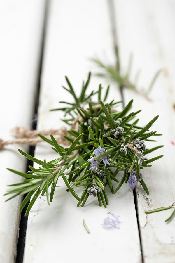 Flowering Rosemary Sprigs On A Wooden Surface Photograph by Mandy Reschke