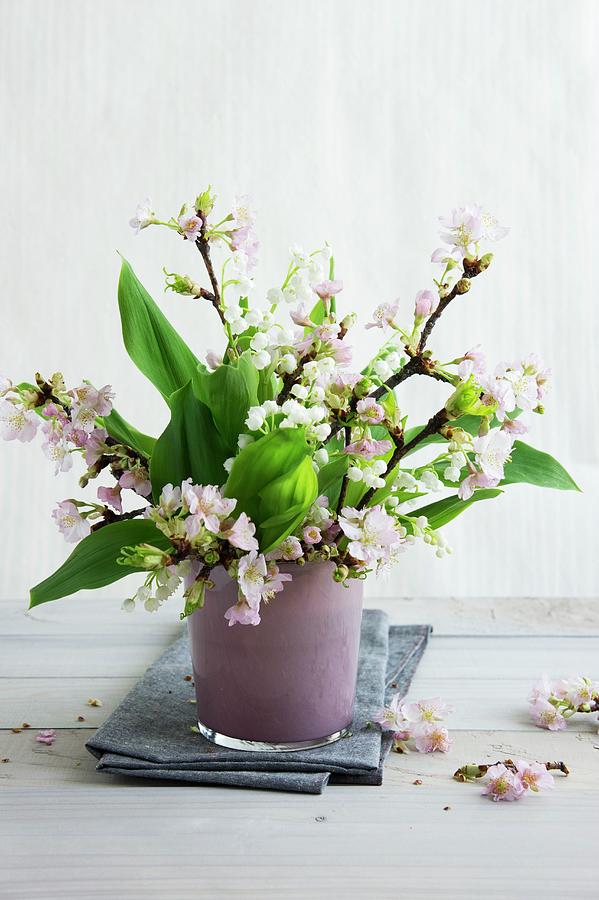 Flowering Twigs And Lily Of The Valley In Pink Glass Vase Photograph by Martina Schindler