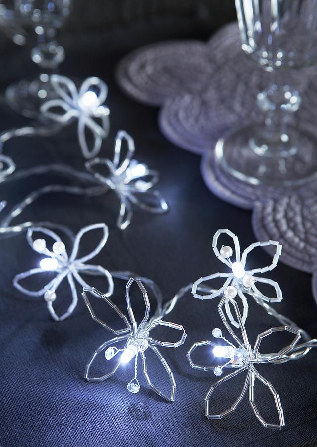 Flowers Hand-crafted From Long Beads Decorating String Of Fairy Lights Photograph by Peter Garten