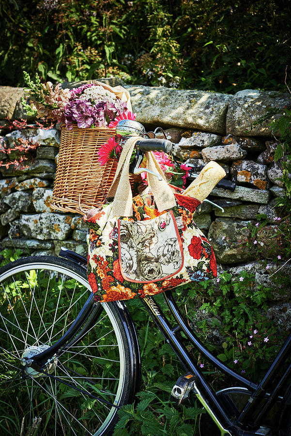 Flowers In Wicker Basket And Baguette In Floral Shopping Bag Hung From ...