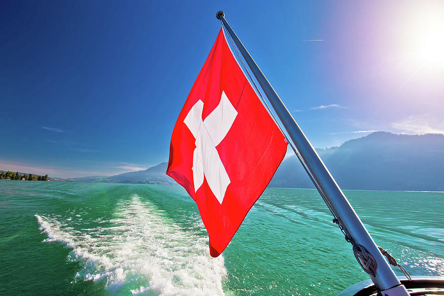 Flowing on idyllic Swiss lake Lucerne boat flag view Photograph by Brch Photography