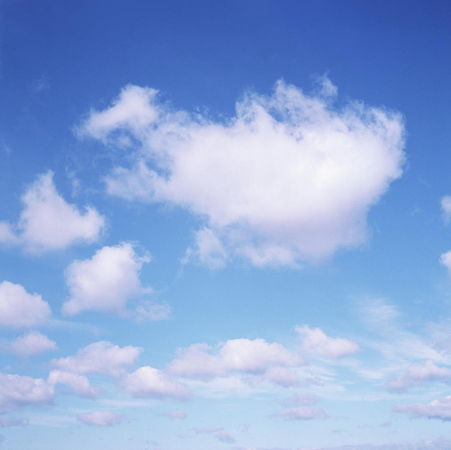 Fluffy White Clouds In Blue Sky Photograph by Dougal Waters