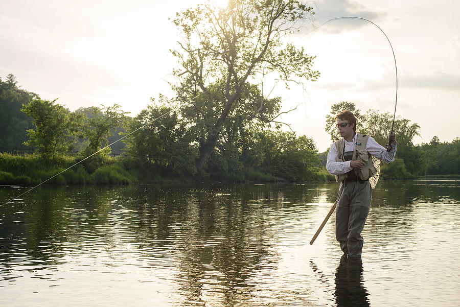 Insects Photograph - Flyfishing At Sunset On A Southeastern River by Cavan Images