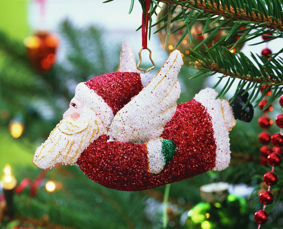 Flying Father Christmas Hanging On Christmas Tree Photograph by Friedrich Strauss