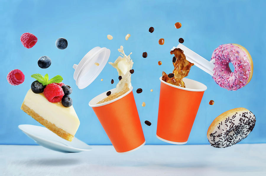 Flying Glasses Of Coffee With Multicolored Donuts And Cheesecake On A Blue Background Photograph by Natasha Arz